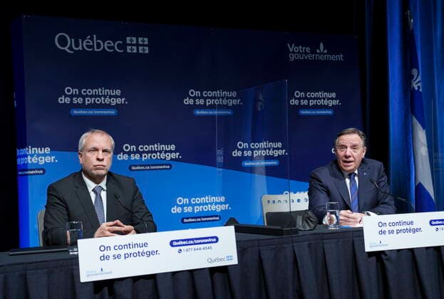 January 11, 2022, Montreal, PQ, Canada: Quebec Premier Francois Legault responds to a question next to interim Quebec Director of Public Health Dr. Luc Boileau during a news conference in Montreal, Tuesday, Jan. 11, 2022. Montreal Canada  - ZUMAc35_ 20220111_zaf_c35_031 Copyright: xPaulxChiassonx