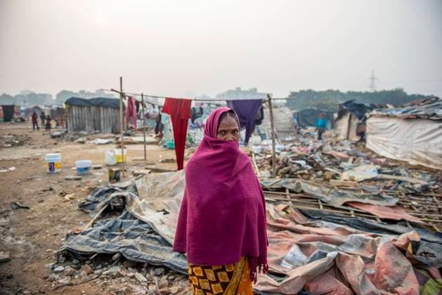 January 13, 2022, Ghaziabad, Uttar Pradesh, India: A woman seen covering her face with shawl living in grim poverty in a derelict area inhabited by cluster of slums..Poor people living in urban slum area of vasundhara, Urban poverty in India is now over 25 percent, close to 81 million people in urban areas live below the poverty line. Several reports indicate that the national level of around 150 199 additional million people will become poor due to COVID-19 crisis, while those who are already poor will be pushed deeper into poverty. Ghaziabad India - ZUMAs197 20220113_zaa_s197_120 Copyright: xPradeepxGaurx