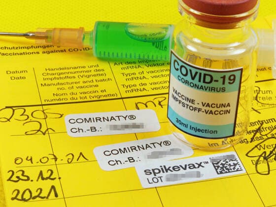 Booster Covid 19 Entry in a vaccination certificate after vaccination with Moderna vaccine with vaccine ampoule Booster vaccination Covid 19