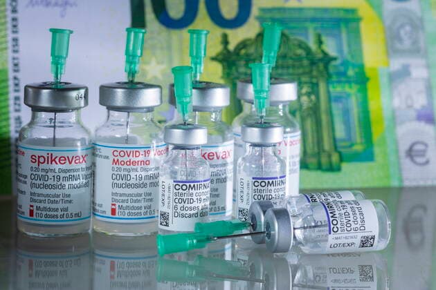 Covid motif icon image Corona and the cost, Covid vaccine in front of Euro banknotes Bannewitz Saxony GERMANY