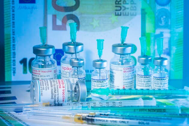 Covid motif icon image Corona and the cost, Covid vaccine in front of Euro banknotes Bannewitz Saxony GERMANY