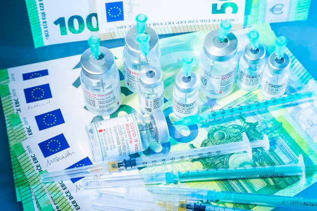 Covid motif icon image Corona and the cost, Covid vaccine in front of Euro banknotes Bannewitz Saxony GERMANY