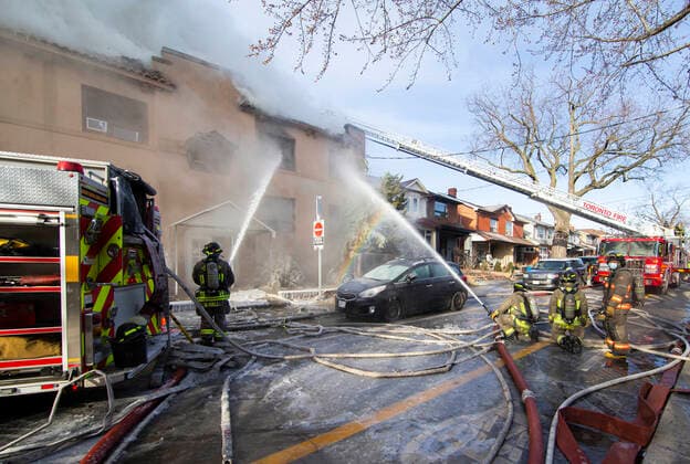(220115) -- TORONTO, Jan. 15, 2022 -- Firefighters work to extinguish a fire burning at an apartment building in Toronto, Canada, on Jan. 15, 2022. Eleven people were rescued, among whom four were taken to hospital following a four-alarm fire at a low-rise apartment building in Toronto on Saturday morning, according to local media. (Photo by Xinhua) CANADA-TORONTO-APARTMENT BUILDING-FIRE ZouxZheng 