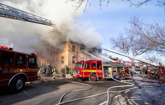 (220115) -- TORONTO, Jan. 15, 2022 -- Firefighters work to extinguish a fire burning at an apartment building in Toronto, Canada, on Jan. 15, 2022. Eleven people were rescued, among whom four were taken to hospital following a four-alarm fire at a low-rise apartment building in Toronto on Saturday morning, according to local media. (Photo by Xinhua) CANADA-TORONTO-APARTMENT BUILDING-FIRE ZouxZheng 