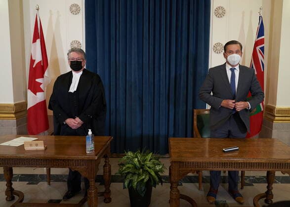 January 18, 2022, Winnipeg, MB, CANADA: Doyle Piwniuk, right, Minister of Transportation and Infrastructure is sworn in as he stands with Richard Chartier, Administrator of the Province at the Manitoba Legislative Building in Winnipeg, Manitoba, Tuesday January 18, 2022. Winnipeg CANADA  - ZUMAc35_ 20220118_zaf_c35_052 Copyright: xDavidxLipnowskix