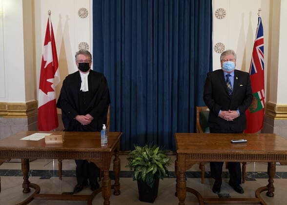 January 18, 2022, Winnipeg, MB, CANADA: Scott Johnston, right, Minister of Seniors and Long-Term Care is sworn in as he stands with Richard Chartier, Administrator of the Province at the Manitoba Legislative Building in Winnipeg, Manitoba, Tuesday January 18, 2022. Winnipeg CANADA  - ZUMAc35_ 20220118_zaf_c35_054 Copyright: xDavidxLipnowskix