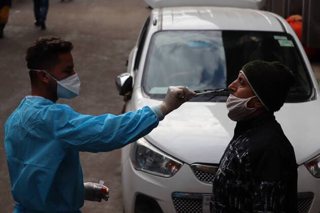 January 20, 2022, Poonch, Jammu and Kashmir, India: A health worker takes a swab sample from a man to perform RT-PCR test following restrictions imposed by the state government amidst rising Covid-19 coronavirus cases in Poonch Poonch India - ZUMAk155 20220120_zip_k155_007 Copyright: xNazimxAlixKhanx