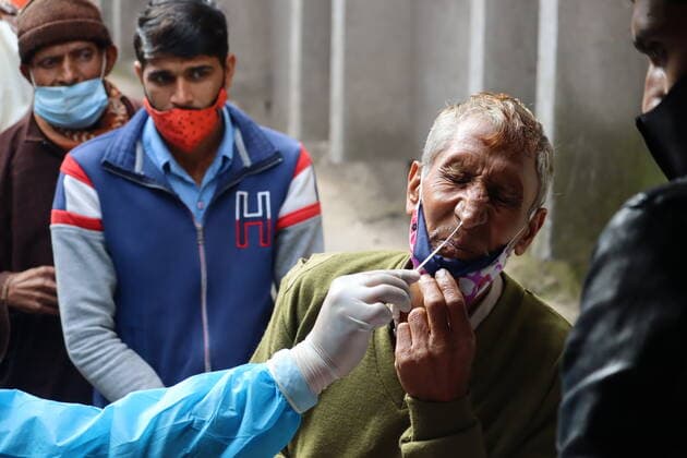 January 20, 2022, Poonch, Jammu and Kashmir, India: A health worker takes a swab sample from a man to perform RT-PCR test following restrictions imposed by the state government amidst rising Covid-19 coronavirus cases in Poonch. Poonch India - ZUMAk155 20220120_zip_k155_005 Copyright: xNazimxAlixKhanx