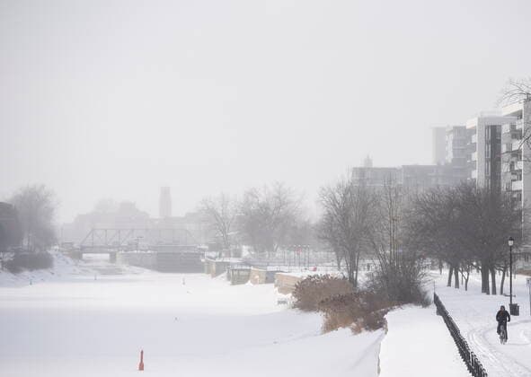 January 21, 2022, Montreal, PQ, Canada: A person cycles along the Lachine Canal in Montreal, Friday, Jan. 21, 2022. Environment Canada has issued an extreme cold warning for the region. Montreal Canada  - ZUMAc35_ 20220121_zaf_c35_009 Copyright: xGrahamxHughesx