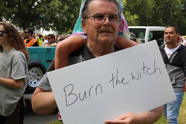 January 22, 2022, Christchurch, Canterbury, New Zealand: A protester holds a placard that reads Burn the witch (in implication at the Prime Minister Jacinda Ardern) during the antivax protest in Merivale..Protesters take to the streets in the affluent suburb of Merivale in protest against the mandatory Covid19 vaccination. Christchurch New Zealand - ZUMAs197 20220122_zaa_s197_021 Copyright: xAdamxBradleyx