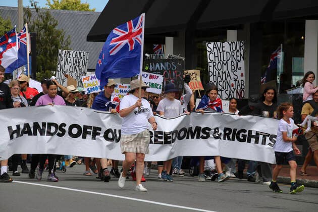 January 22, 2022, Christchurch, Canterbury, New Zealand: Protesters march with a banner reading hands off our freedoms and rights during the antivax protest in Merivale..Protesters take to the streets in the affluent suburb of Merivale in protest against the mandatory Covid19 vaccination. Christchurch New Zealand - ZUMAs197 20220122_zaa_s197_033 Copyright: xAdamxBradleyx