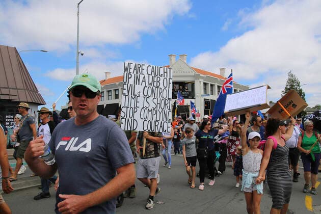 January 22, 2022, Christchurch, Canterbury, New Zealand: Protesters march with placards, banners, and flags during the antivax protest in Merivale..Protesters take to the streets in the affluent suburb of Merivale in protest against the mandatory Covid19 vaccination. Christchurch New Zealand - ZUMAs197 20220122_zaa_s197_035 Copyright: xAdamxBradleyx