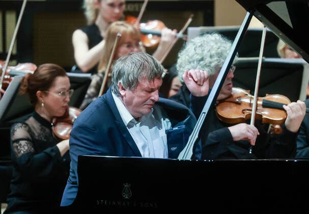 MOSCOW, RUSSIA â€” JANUARY 22, 2022: Pianist Boris Berezovsky (front) performs with the Mariinsky Theatre Symphony Orchestra at Zaryadye Concert Hall. The concert was organised by Valery Gergiev Foundation. Sergei Fadeichev TASS  TS11FFE0
