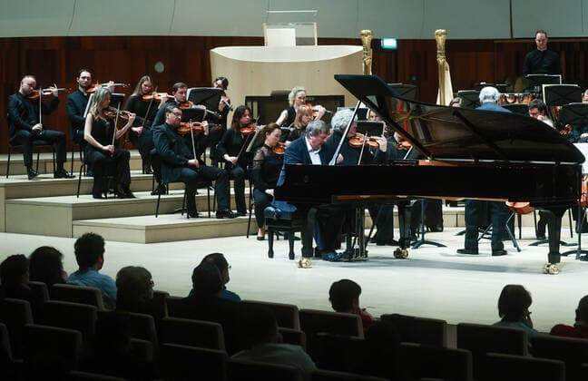 MOSCOW, RUSSIA â€” JANUARY 22, 2022: Pianist Boris Berezovsky (C) and conductor Valery Gergiev (R midground standing) perform with the Mariinsky Theatre Symphony Orchestra at Zaryadye Concert Hall. The concert was organised by Valery Gergiev Foundation. Sergei Fadeichev TASS  TS11FFE1