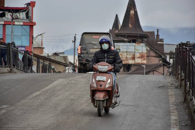 January 22, 2022, Srinagar, Jammu & Kas, India: A man wears a face mask as he rides through a road during a lockdown imposed by the authorities following the surge in coronavirus cases in Srinagar..Kashmir has been witnessing an exponential surge in Covid-19 cases following which authorities imposed a 64-hour lockdown to curb the surge. Jammu and Kashmir on Friday reported 5,720 coronavirus cases and five deaths. Meanwhile, India reported 337,704 new Covid-19 cases in the last 24 hours. Srinagar India - ZUMAs197 20220122_zaa_s197_049 Copyright: xSaqibxMajeedx