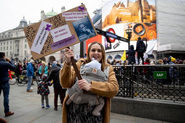 January 22, 2022, London, United Kingdom: A demonstrator holds a placard during the demonstration..Thousands of people marched on the street in Central London to protest against mandatory COVID vaccination to all NHS staff by 1st April 2022. The national call of action was organised by NHS100K who estimated there are over 100,000 of health and social care staff would lose their jobs over the mandates. They called for an open dialogue with Sajid Javid, the current Secretary of State for Health and Social Care of the UK government, regarding the issues on making COVID vaccination mandatory for NHS staff. London United Kingdom - ZUMAs197 20220122_zaa_s197_091 Copyright: xHestherxNgx