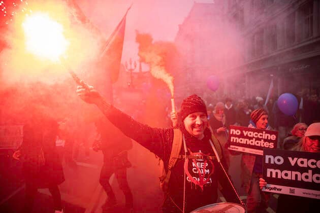 January 22, 2022, London, England, United Kingdom: A protester holds up a burning flare while marching through central London during the demonstration..Protesters marched through central London during a worldwide rally for freedom - protesting against government restrictions surrounding Covid 19 including mandatory vaccinations, particularly with NHS staff, who may face losing their job if they refuse to get vaccinated. London United Kingdom - ZUMAs197 20220122_zaa_s197_211 Copyright: xChristopherxWallsx