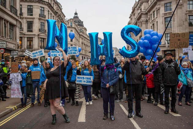 January 22, 2022, London, England, United Kingdom: NHS staff pose for camera as they march through central London during the demonstration..Protesters marched through central London during a worldwide rally for freedom - protesting against government restrictions surrounding Covid 19 including mandatory vaccinations, particularly with NHS staff, who may face losing their job if they refuse to get vaccinated. London United Kingdom - ZUMAs197 20220122_zaa_s197_214 Copyright: xChristopherxWallsx