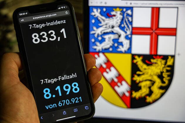 Coronavirus in Germany Covid 19 Dashboard of the Robert Koch Institute DEU, Germany, Saarland 23 01 2022 The 7-day incidence for the state Cases last 7 days 100 000 p.e. is displayed on an iPhone, with the state coat of arms in the background.