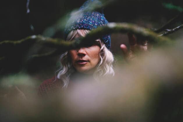 Woman with gray hair behind tree branch in forest model released, SIPF02716
