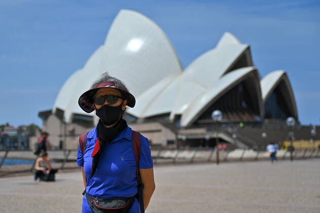 NSW CORONAVIRUS COVID19, People wearing masks walk in front of the Sydney Opera House at Circular Quay in Sydney, Tuesday, January 25, 2022. ( NO ARCHIVING, EDITORIAL USE ONLY, NO USE IN BOOKS WITHOUT CONSENT SYDNEY NSW AUSTRALIA  Copyright: xSTEVENxSAPHOREx 20220125001616804290