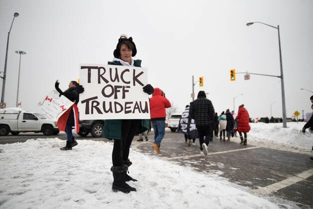 The Freedom Rally Supporter with sign denouncing Prime Minister Justin Trudeau during The Freedom Rally to protest the mandatory vaccine policy imposed on the Canadian truckers returning from USA to avoid a two week quarantine in Vaughan-Ontario in Canada. Vaughan Canada  Copyright: xArindamxShivaanix originalFilename: shivaanibahuguna-notitle220127_np10w.jpg