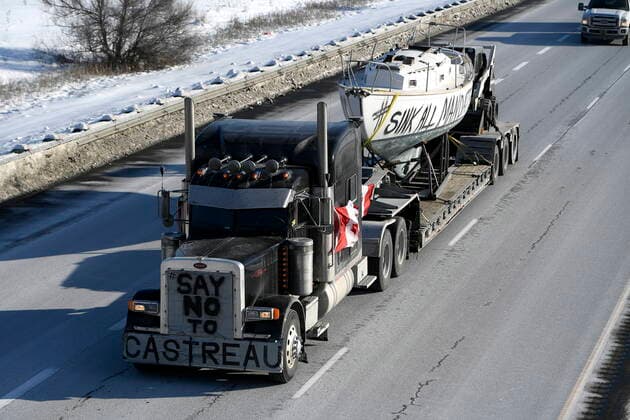 January 28, 2022, Ottawa, ON, CAN: A truck towing a boat inscribed with the words öÄuSink All MandatesöÄÃ¹ makes its way along Highway 416 as part of a cross-country convoy protesting a federal vaccine mandate for truckers in Ottawa, on Friday, Jan. 28, 2022. Ottawa CAN  - ZUMAc35_ 20220128_zaf_c35_040 Copyright: xJustinxTangx