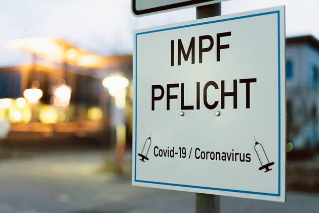 29 January 2022: Sign saying compulsory vaccination - Covid 19 coronavirus compulsory vaccination symbol image - PHOTOMONTAGE