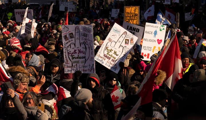 January 29, 2022, Ottawa, ON, Canada: Protesters participating in a cross-country truck convoy protesting measures taken by authorities to curb the spread of COVID-19 and vaccine mandates gather and hold signs with explicit language near Parliament Hill in Ottawa on Saturday, Jan. 29, 2022. Ottawa Canada  - ZUMAc35_ 20220129_zaf_c35_042 Copyright: xAdrianxWyldx
