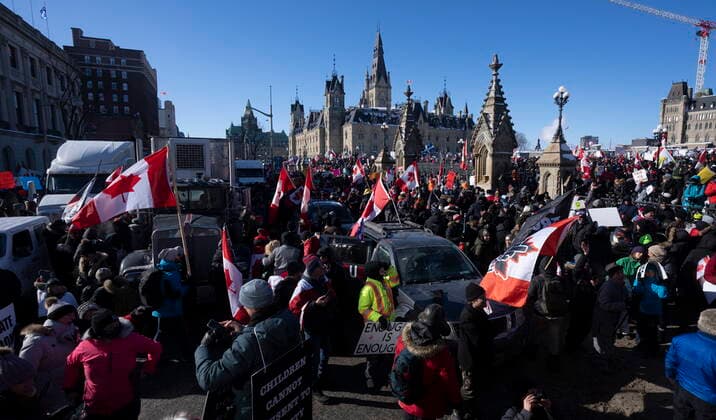 January 29, 2022, Ottawa, ON, Canada: Protestors mingle around vehicles parked on Wellington St. in front of West Block and the Parliament buildings as they participate in a cross-country truck convoy protesting measures taken by authorities to curb the spread of COVID-19 and vaccine mandates in Ottawa on Saturday, Jan. 29, 2022. Ottawa Canada  - ZUMAc35_ 20220129_zaf_c35_056 Copyright: xAdrianxWyldx