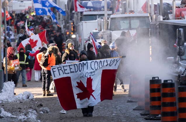 January 29, 2022, Ottawa, ON, Canada: Protesters participating in a cross-country truck convoy protesting measures taken by authorities to curb the spread of COVID-19 and vaccine mandates walk near Parliament Hill in Ottawa on Saturday, Jan. 29, 2022. Ottawa Canada  - ZUMAc35_ 20220129_zaf_c35_058 Copyright: xAdrianxWyldx