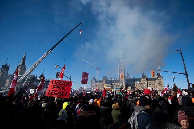 January 29, 2022, Ottawa, ON, CAN: Smoke floats in the air as people gather on Parliament Hill during a rally against COVID-19 restrictions on Parliament Hill is seen on a television screen in a media room in Ottawa, on Saturday, Jan. 29, 2022. Authorities expect at least 10,000 people to attend; the rally began as a cross-country convoy protesting a federal vaccine mandate for truckers. Ottawa CAN  - ZUMAc35_ 20220129_zaf_c35_064 Copyright: xJustinxTangx