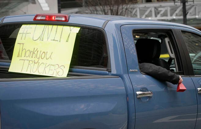 (220130) -- VANCOUVER, Jan. 30, 2022 -- A vehicle with a protest sign runs along the street during a parade in support of Ottawa s Freedom Convoy trucker protest in downtown Vancouver, British Columbia, Canada, Jan. 29, 2022. Vehicles jammed downtown Vancouver streets Saturday to show their support of the Freedom Convoy of long-haul drivers to oppose the Canadian government s requirement that all cross-border essential workers, including truckers, must show proof of vaccination at a port of entry. (Photo by Xinhua) CANADA-VANCOUVER-FREEDOM CONVOY-SUPPORT-PARADE LiangxSen 