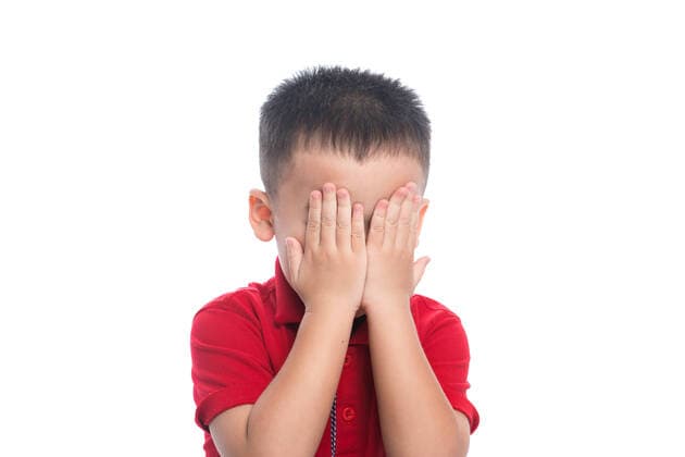 Portrait of cute smiling little boy closed eyes with his hand in studio Copyright: xx 43814086