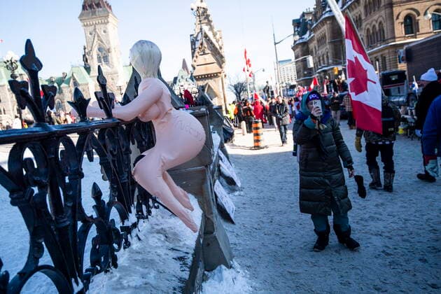 January 30, 2022, Ottawa, ON, CAN: A blow up doll inscribed with the name of Prime Minister Justin Trudeau is affixed to the gates of Parliament Hill during a rally against COVID-19 restrictions on Parliament Hill, which began as a cross-country convoy protesting a federal vaccine mandate for truckers, in Ottawa, on Sunday, Jan. 30, 2022. Ottawa CAN  - ZUMAc35_ 20220130_zaf_c35_008 Copyright: xJustinxTangx