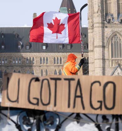 February 1, 2022, Ottawa, ON, Canada: A protestor walks in front of Parliament on Tuesday, Feb. 1, 2022 in Ottawa. As organizers behind the demonstration that has seized the nation s capital say they are preparing to stick around even longer by distributing fuel and supplies to the trucks clogging up Ottawa streets, politicians at all levels of government are asking them to roll out. Ottawa Canada  - ZUMAc35_ 20220201_zaf_c35_030 Copyright: xAdrianxWyldx