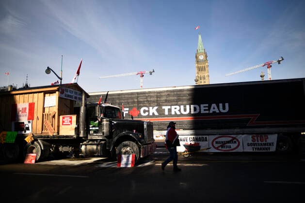 4th Day Of Trucker s Protest At Parliament Hill A supporter passes by a truck having a derogatory word against Prime minister Trudeau during the 4th Day of Trucker s protest against the mandatory vaccine policy imposed on the Canadian truckers returning from USA to avoid a two week quarantine at Parliament Hill in Ottawa-Canada Ottawa Canada  Copyright: xArindamxShivaanix originalFilename: shivaanibahuguna-notitle220201_npl6S.jpg