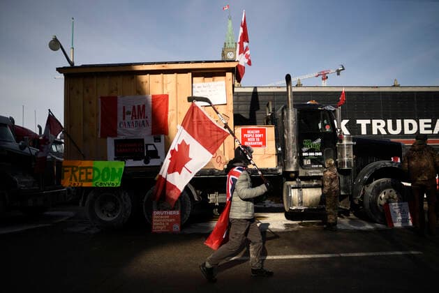 4th Day Of Trucker s Protest At Parliament Hill A supporter carrying a Canadian National Flag during the 4th Day of Trucker s protest against the mandatory vaccine policy imposed on the Canadian truckers returning from USA to avoid a two week quarantine at Parliament Hill in Ottawa-Canada Ottawa Canada  Copyright: xArindamxShivaanix originalFilename: shivaanibahuguna-notitle220201_np2LV.jpg