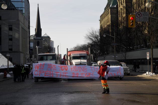 4th Day Of Trucker s Protest At Parliament Hill A supporter taking picture in front of lined up trucks with banners and signs next to the Parliament building during the 4th Day of Trucker s protest against the mandatory vaccine policy imposed on the Canadian truckers returning from USA to avoid a two week quarantine at Parliament Hill in Ottawa-Canada Ottawa Canada  Copyright: xArindamxShivaanix originalFilename: shivaanibahuguna-notitle220201_npUb6.jpg