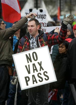 (220206) -- VANCOUVER, Feb. 6, 2022 -- A man carries a sign during a convoy of truckers opposed to COVID-19 vaccine mandate in downtown Vancouver, Canada, Feb. 5, 2022. In solidarity with protesters in downtown Ottawa, anti COVID-19 vaccine mandates and restrictions supporters in Vancouver took part in vehicle convoys and rallies protesting against Canadian government s vaccine mandate for essential workers crossing the Canada-U.S. border. (Photo by Xinhua) CANADA-VANCOUVER-COVID-19-CONVOY PROTEST LiangxSen 