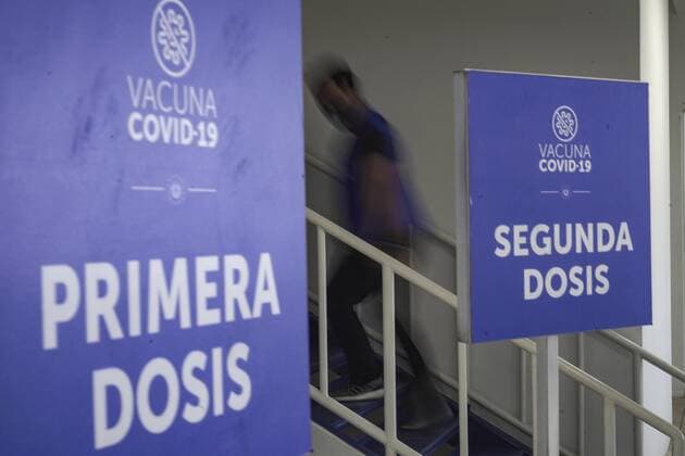 February 6, 2022: A man walks by signs announcing first and second doses of the COVID-19 vaccine. The Salvadoran Ministry of Health announced it had surpassed 10 million vaccine doses applied. - ZUMAf143 20220206_zip_f143_006 Copyright: xCamiloxFreedmanx