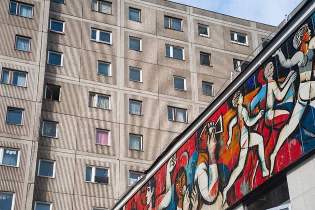 05 02 2022, Berlin, Germany, Europe GDR frieze wall mosaic with the title The press as an organizer at the former Pressecafe Berlin low-rise building at Alexanderplatz by the painter Willi Neubert Adjacent to it a typical prefabricated slab building with apartments