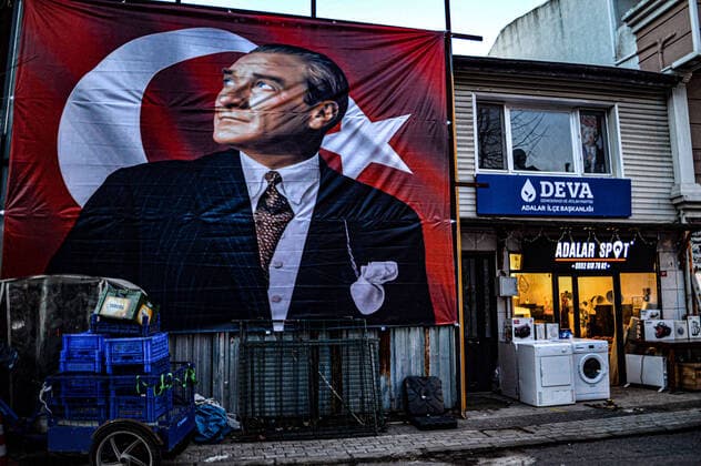 Turkey s economic crisis deepens A Turkish national flag picturing modern Turkey s founder Mustafa Kemal Ataturk is displayed next to a spot market in Istanbul, Turkey, on Friday, February 11, 2022. Turkey s ongoing economic crisis deepens, reflecting severe price hikes on consumer goods, energy costs and housing expenses. Istanbul Turkey gocherimagery220211_023  Copyright: xAltanxGocher GocherImageryx