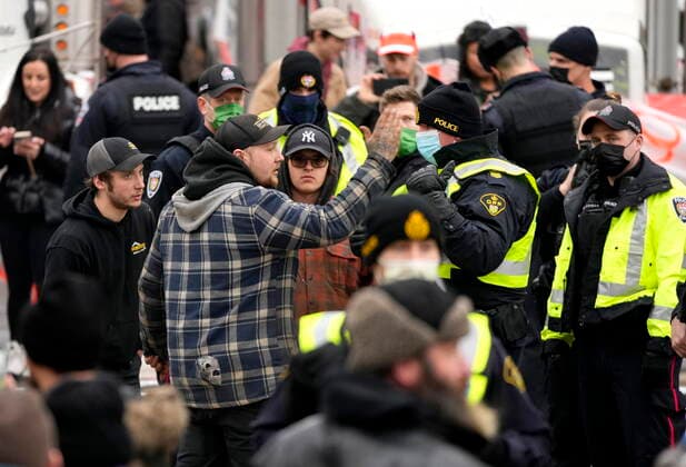 February 11, 2022, Ottawa, ON, CAN: Police negotiate with protesters who began setting up a tent structure on Wellington Street, on the 15th day of a protest against COVID-19 measures that has grown into a broader anti-government protest, in Ottawa, Friday, Feb. 11, 2022. Ottawa CAN  - ZUMAc35_ 20220211_zaf_c35_165 Copyright: xJustinxTangx