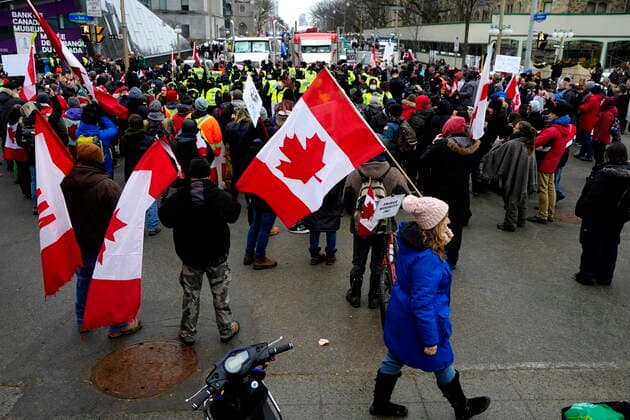 February 11, 2022, Ottawa, ON, CAN: Police are surrounded by onlooking protesters as they form a ring around protesters who intended to set up a tent structure in the intersection of Bank and Wellington Streets, on the 15th day of a protest against COVID-19 measures that has grown into a broader anti-government protest, in Ottawa, Friday, Feb. 11, 2022. Police negotiated with the protesters to remove their building hardware and generators. Ottawa CAN  - ZUMAc35_ 20220211_zaf_c35_169 Copyright: xJustinxTangx
