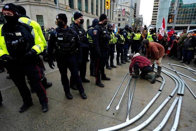 February 11, 2022, Ottawa, ON, CAN: Protesters pack up materials for building a tent structure on Wellington Street after police intervened, on the 15th day of a protest against COVID-19 measures that has grown into a broader anti-government protest, in Ottawa, Friday, Feb. 11, 2022. Ottawa CAN  - ZUMAc35_ 20220211_zaf_c35_171 Copyright: xJustinxTangx