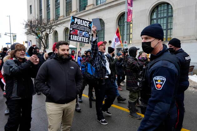 February 11, 2022, Ottawa, ON, CAN: A protester screams at police as other officers escort a group of protesters away from Wellington Street after they began to construct a tent structure in the intersection, on the 15th day of a protest against COVID-19 measures that has grown into a broader anti-government protest, in Ottawa, Friday, Feb. 11, 2022. Ottawa CAN  - ZUMAc35_ 20220211_zaf_c35_174 Copyright: xJustinxTangx