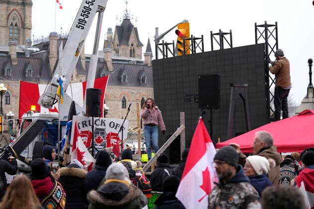 February 11, 2022, Ottawa, ON, CAN: A protester sings on a stage as another works on a giant TV screen behind, in front of Parliament Hill, on the 15th day of a protest against COVID-19 measures that has grown into a broader anti-government protest, in Ottawa, Friday, Feb. 11, 2022. Ottawa CAN  - ZUMAc35_ 20220211_zaf_c35_176 Copyright: xJustinxTangx