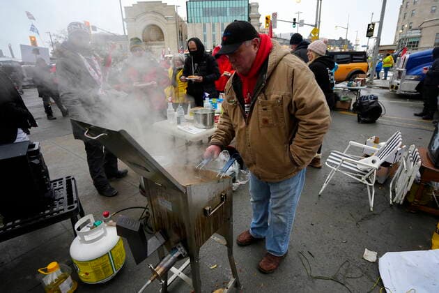 February 11, 2022, Ottawa, ON, CAN: A protester prepares french fries in a deep fryer along Sussex Drive on the 15th day of a protest against COVID-19 measures that has grown into a broader anti-government protest, in Ottawa, Friday, Feb. 11, 2022. Ottawa CAN  - ZUMAc35_ 20220211_zaf_c35_177 Copyright: xJustinxTangx