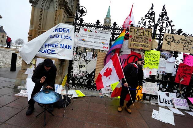 February 11, 2022, Ottawa, ON, CAN: Protesters drum, dance and smoke in front of the QueenöÄÃ s Gates on Parliament Hill, on the 15th day of a protest against COVID-19 measures that has grown into a broader anti-government protest, in Ottawa, Friday, Feb. 11, 2022. Ottawa CAN  - ZUMAc35_ 20220211_zaf_c35_178 Copyright: xJustinxTangx
